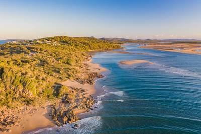 Beautiful aerial image of a seaside village with small beach and gentle blue waves
