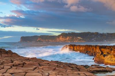 Sunrise, sea, waves, clouds and tessellated rock platform