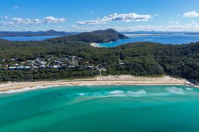 Aerial scene capturing the clear waters of Boomerang Beach near Pacific Palms, NSW, Australia