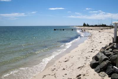 View along the beach towards small pier