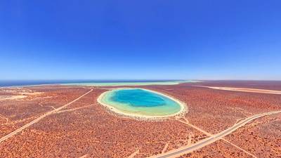 Aerial View of Turquoise Circular Little Lagoon and Arid Coastline With Sandy Beach and Desert Roads, Shark Bay, Denham, Western Australia