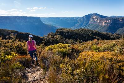 Adventurous female hiker descending down the mountain