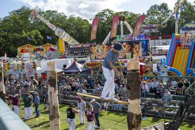 Woodchop Competitor Balancing on Log During Competition