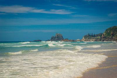 Beautiful Coastal Scenery of Narooma Surf Beach in New South Wales, with Glasshouse Rocks in background