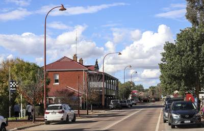 Street view historic town, featuring colonial brick architecture, classic street lamps. Blue sky, white cumulus clouds. Copy space.…