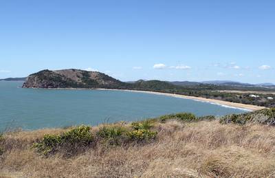 View of Kemp Beach with the ocean, sand, trees and grass from the Fan Rock Lookout at Yeppoon in Queensland, Australia